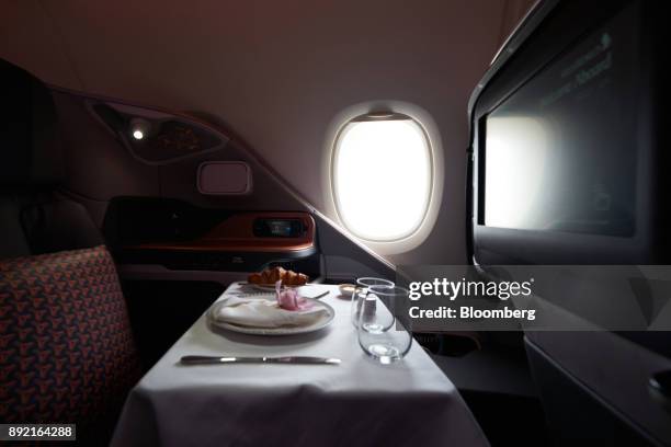 Breakfast table is prepared for a business class seat of a Singapore Airlines Ltd. Airbus SE A380 aircraft with refitted cabins during a media tour...