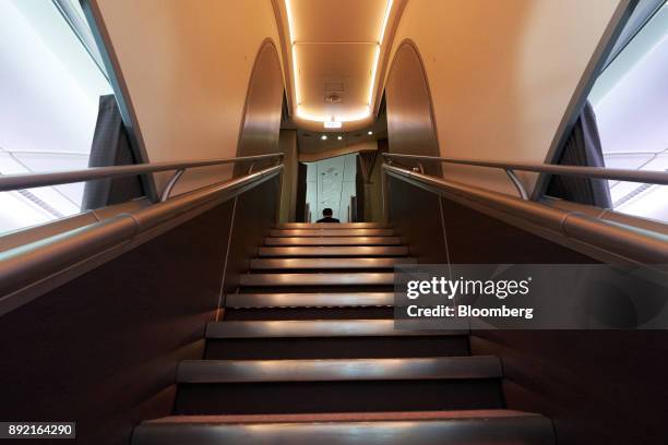 Staircase leads to business class seats and suites inside a Singapore Airlines Ltd. Airbus SE A380 aircraft with refitted cabins during a media tour...
