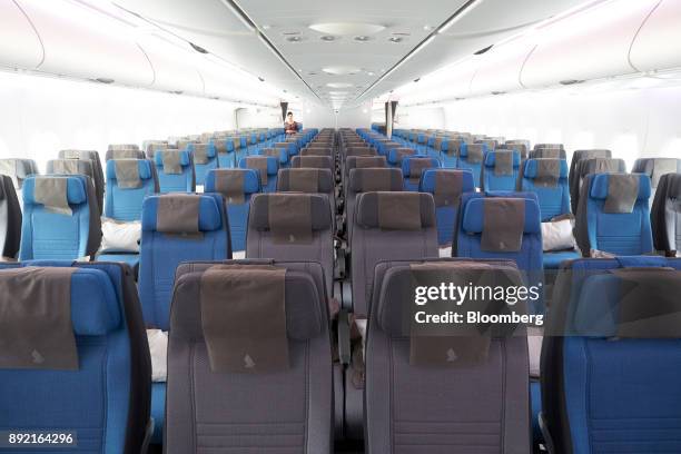 Economy class seats of a Singapore Airlines Ltd. Airbus SE A380 aircraft with refitted cabins are seen during a media tour at Changi Airport in...