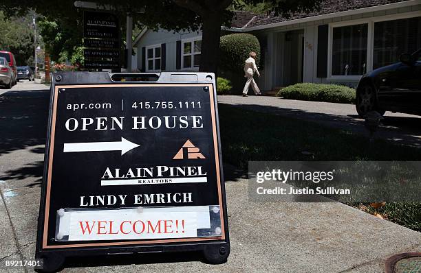 Real estate agent walks into a home during a brokers open house July 23, 2009 in San Rafael, California. The National Association of Realtors...