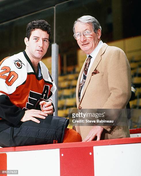 Kevin Dineen and father Bill Dineen head coach of the Philadelphia Flyers pose for a photo before the game against the Boston Bruins at the Boston...