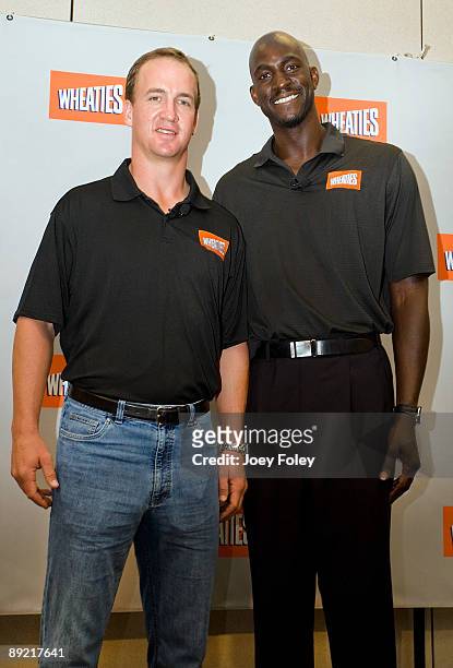 Indianapolis Colts quarterback Peyton Manning and NBA star Kevin Garnett pose for a photograph after a press conference at Conseco Fieldhouse on July...