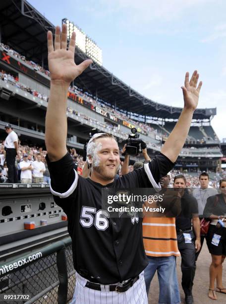 Mark Buehrle of the Chicago White Sox waves to the crowd after recording the 18th perfect game in major league history against the Tampa Bay Rays on...