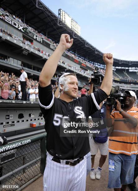 Mark Buehrle of the Chicago White Sox waves to the crowd after recording the 18th perfect game in major league history against the Tampa Bay Rays on...