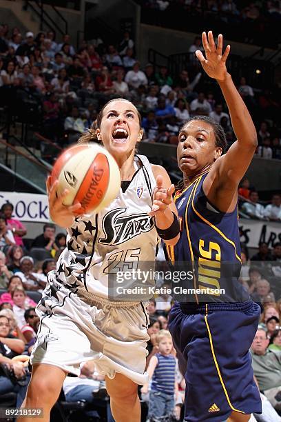 Becky Hammon of the San Antonio Silver Stars lays the ball up over Tan White of the Connecticut Sun during the WNBA game on July 17, 2009 at the AT&T...