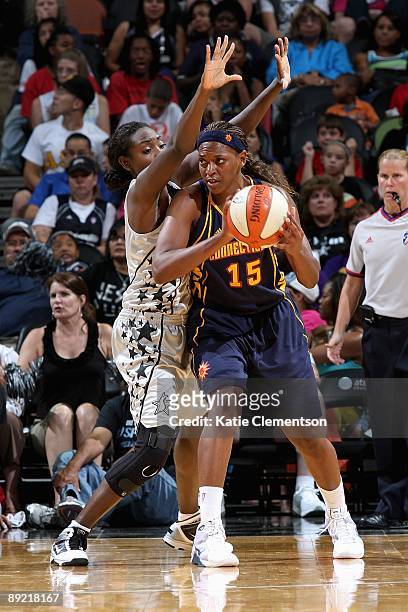 Asjha Jones of the Connecticut Sun goes up against Sophia Young of the San Antonio Silver Stars during the WNBA game on July 17, 2009 at the AT&T...