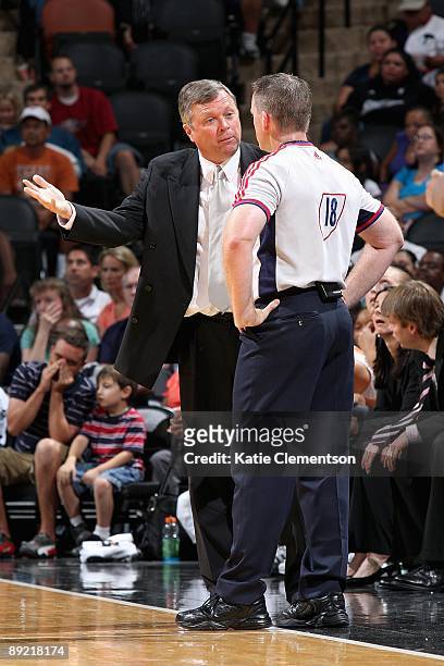 Head coach Dan Hughes of the San Antonio Silver Stars discusses a call with referee Kurt Walker during the WNBA game against the Connecticut Sun on...