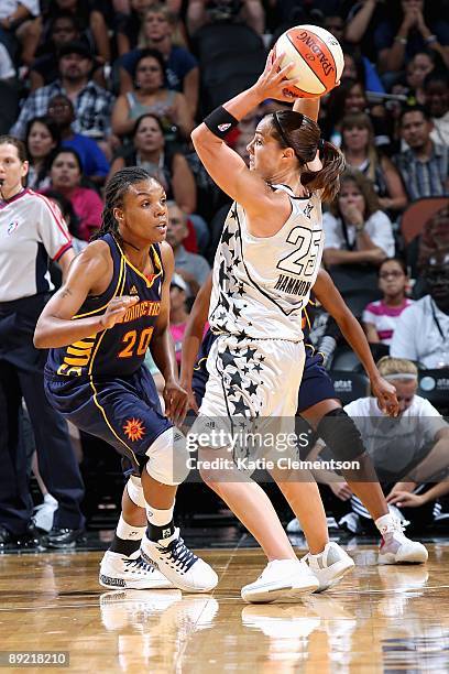 Becky Hammon of the San Antonio Silver Stars looks to pass over Tan White of the Connecticut Sun during the WNBA game on July 17, 2009 at the AT&T...