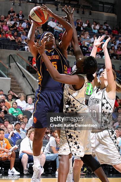 Asjha Jones of the Connecticut Sun goes up for a shot over Sophia Young of the San Antonio Silver Stars during the WNBA game on July 17, 2009 at the...