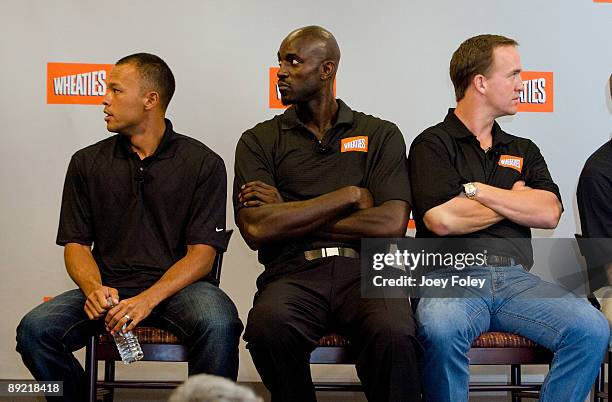 Gold medal winning decathlete Bryan Clay, NBA star Kevin Garnett, and Indianapolis Colts quarterback Peyton Manning as they watch a promotional video...