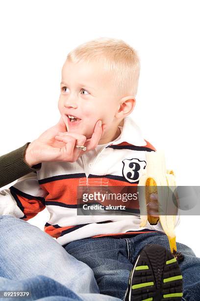menino comer uma banana xxl - head forward white background imagens e fotografias de stock