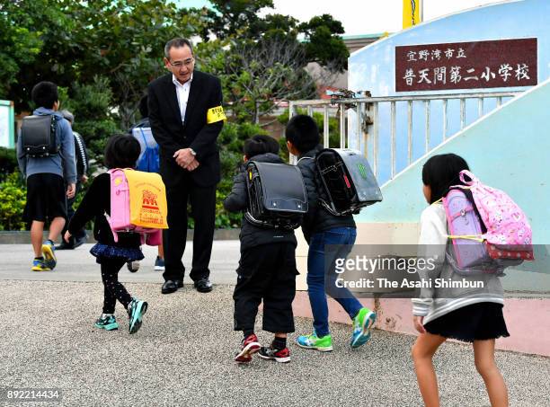 Children arrive at Futenma Daini Elementary School on December 14, 2017 in Ginowan, Okinawa, Japan. The latest mishap involved a metal window frame...