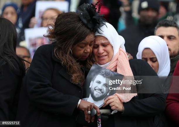 Mourners take a moment as they leave the Grenfell Tower National Memorial service at St Paul's cathedral on December 14, 2017 in London, England. The...