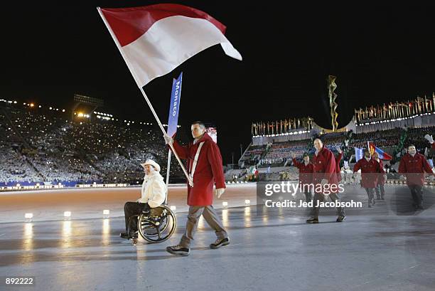 Men's bobsleder and Monaco flag bearer Jean-Francois Calmes leads his country into the stadium during the Opening Ceremony of the Salt Lake City...