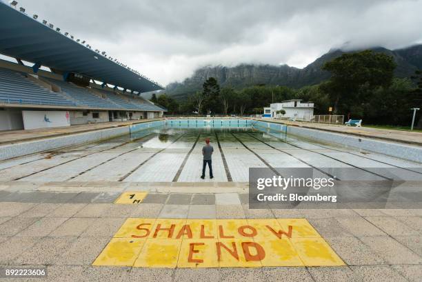 Person stands in the pool to demonstrate the severely low water level at the Newlands municipal swimming pool in Cape Town, South Africa on Monday,...