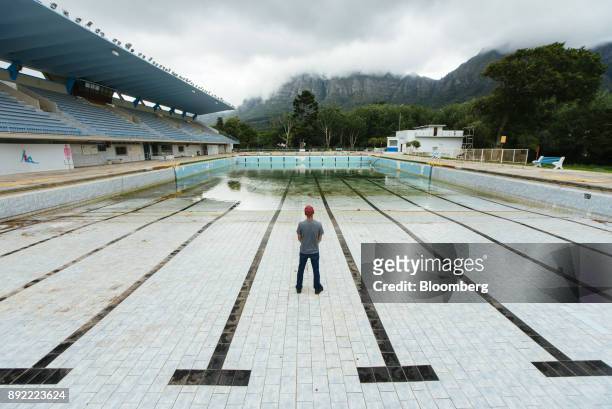 Person stands in the pool to demonstrate the severely low water level at the Newlands municipal swimming pool in Cape Town, South Africa on Monday,...