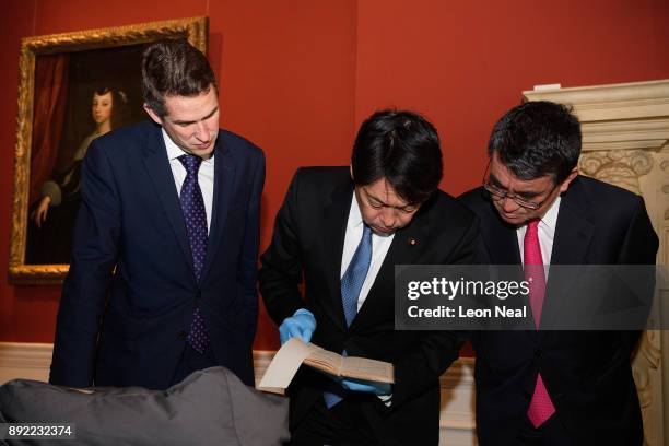 Defence Secretary Gavin Williamson , Japanese Defence Minister Itsunori Onodera and Japan's Foreign Minister Taro Kono examine a selection of...