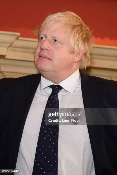 British Foreign Secretary Boris Johnson looks on as Japanese Defence Minister Itsunori Onodera and Japan's Foreign Minister Taro Kono examine a...