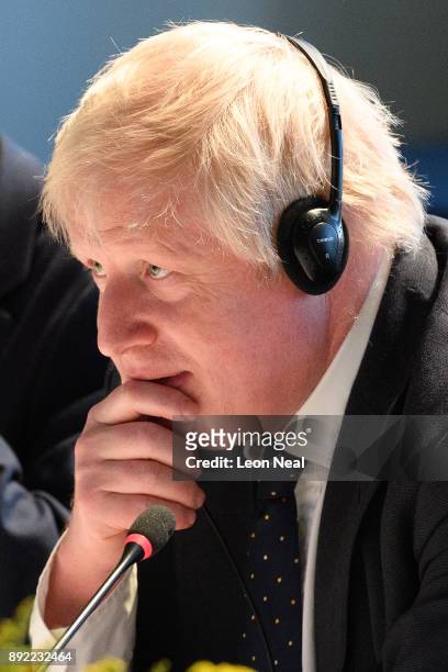 British Foreign Secretary Boris Johnson looks on as Japanese Defence Minister Itsunori Onodera and Japan's Foreign Minister Taro Kono make their...