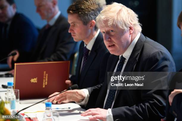 British Foreign Secretary Boris Johnson looks on as Japanese Defence Minister Itsunori Onodera and Japan's Foreign Minister Taro Kono make their...