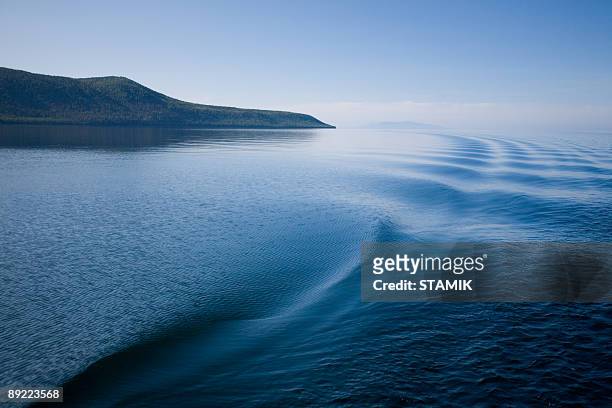 traces on the water - smooth sailing stock pictures, royalty-free photos & images