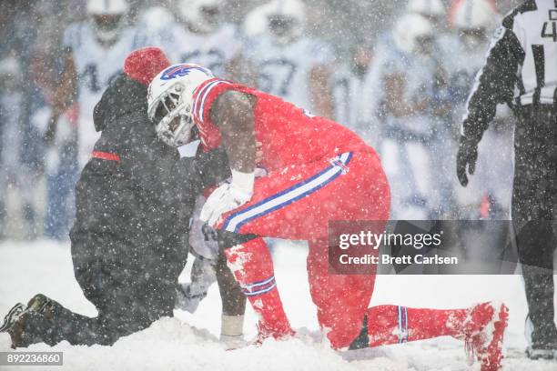 Jordan Mills of the Buffalo Bills is helped off the field by trainers during the third quarter against the Indianapolis Colts at New Era Field on...