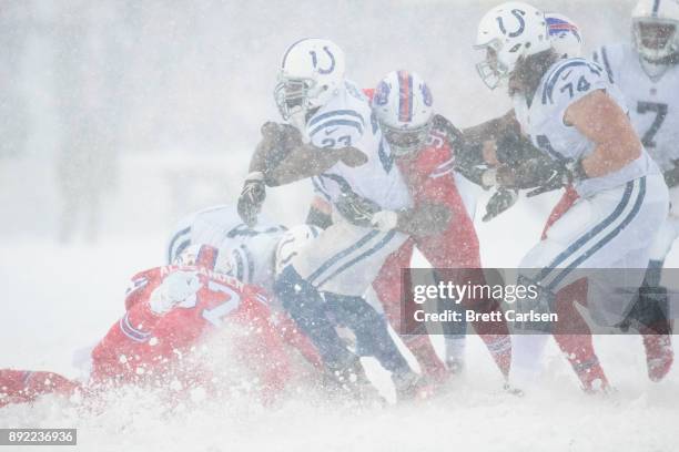 Frank Gore of the Indianapolis Colts is brought down by Adolphus Washington of the Buffalo Bills during the second half at New Era Field on December...