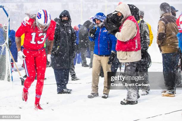 Kelvin Benjamin of the Buffalo Bills jogs on the sideline with trainers watching during the second half against the Indianapolis Colts at New Era...