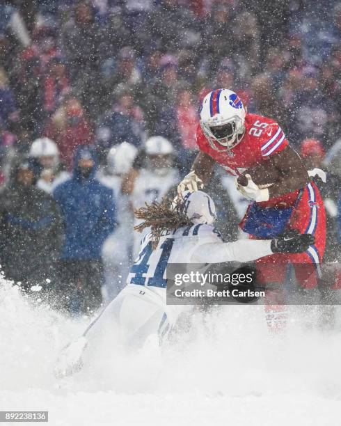 LeSean McCoy of the Buffalo Bills runs with the ball as Matthias Farley of the Indianapolis Colts attempts to tackle McCoy during overtime at New Era...