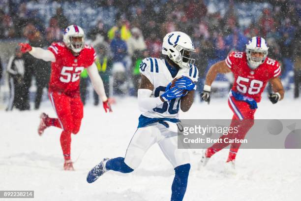 Chester Rogers of the Indianapolis Colts runs with the ball during overtime against the Buffalo Bills at New Era Field on December 10, 2017 in...