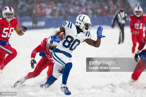 Chester Rogers of the Indianapolis Colts evades Tre'Davious White of the Buffalo Bills while carrying the ball during overtime at New Era Field on...