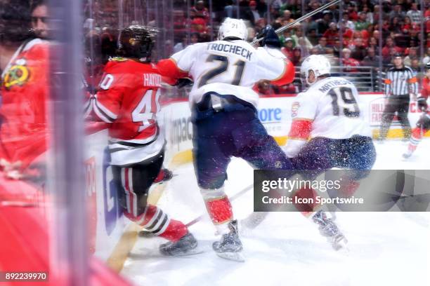 Florida Panthers center Vincent Trocheck checks Chicago Blackhawks right wing John Hayden into the boards in action during the second period of a...