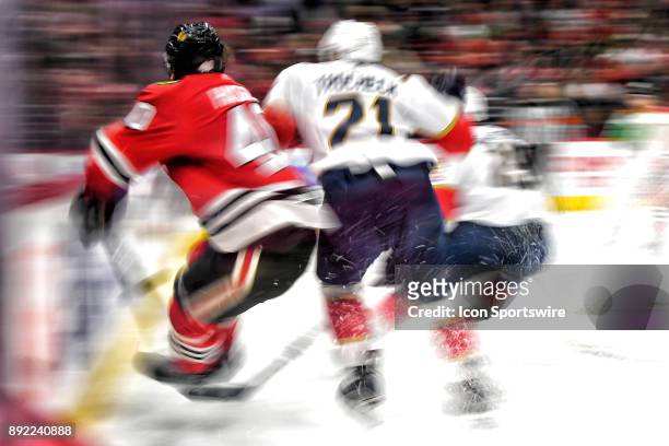 Florida Panthers center Vincent Trocheck checks Chicago Blackhawks right wing John Hayden into the boards in action during the second period of a...