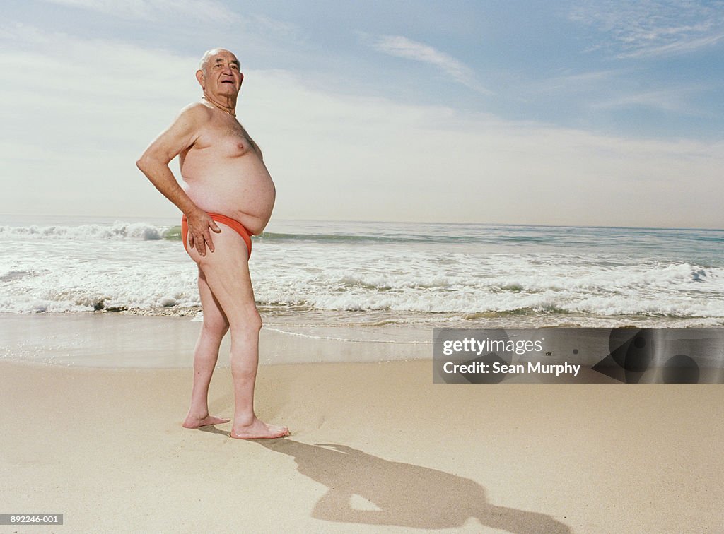 Mature man wearing swimsuit on beach