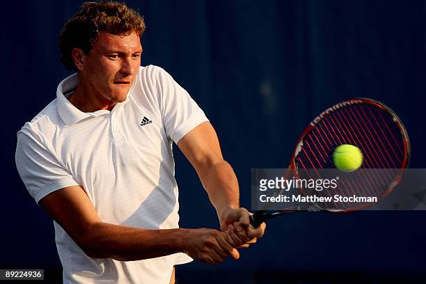 Denis Istomin of Uzebekistan returns a shot to John Isner during the Indianapolis Tennis Championships on July 23, 2009 at the Indianapolis Tennis...