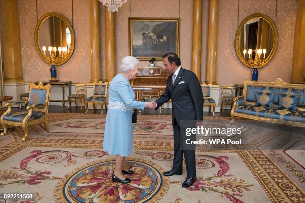 Queen Elizabeth II meets the Sultan of Brunei during a private audience at Buckingham Palace on December 14, 2017 in London, England.