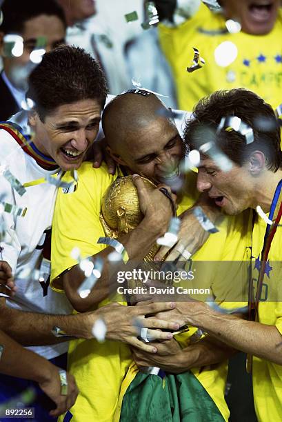 Edmilson, Roberto Carlos and Juninho Paulista of Brazil celebrate with the trophy after the Germany v Brazil, World Cup Final match played at the...