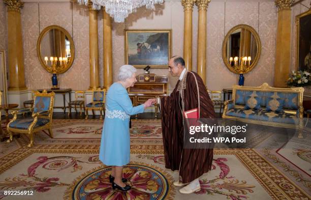 Queen Elizabeth II meets Mr Nabil Ben Khedher, Ambassador of Tunisia, during a private audience at Buckingham Palace on December 14, 2017 in London,...