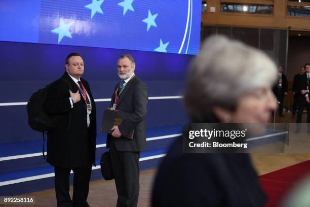 Tim Barrow, U.K. Permanent representative to the European Union , center, looks towards Theresa May, U.K. Prime minister, right, as she speaks with...