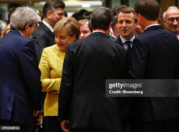 Angela Merkel, Germany's chancellor, second left, speaks to Paolo Gentiloni, Italy's prime minister, left, as Emmanuel Macron, France's president,...