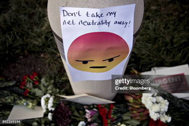 Sign displaying opposition to the roll back of net neutrality rules hangs outside the Federal Communications Commission headquarters ahead of a open...