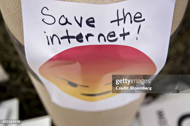 Save The Internet" sign hangs outside the Federal Communications Commission headquarters ahead of a open commission meeting in Washington, D.C.,...