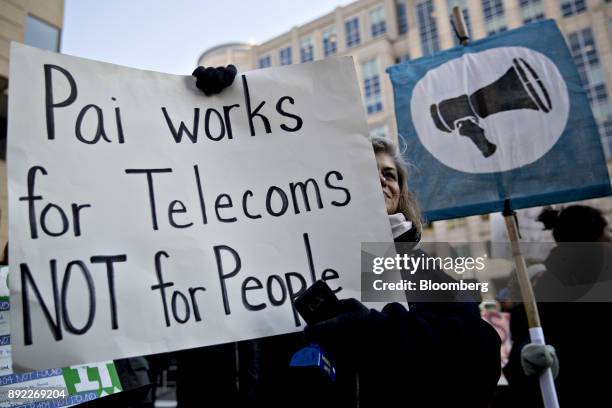 Demonstrator opposed to the roll back of net neutrality rules holds a sign outside the Federal Communications Commission headquarters ahead of a open...