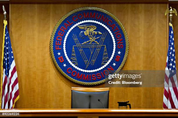 The Federal Communications Commission seal hangs inside a meeting room at the headquarters ahead of a open commission meeting in Washington, D.C.,...