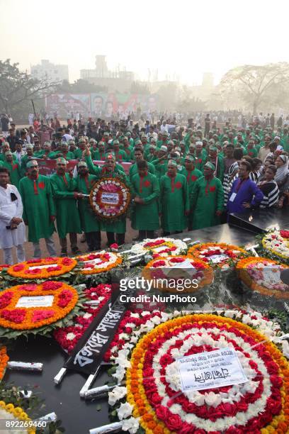 Bangladeshis place floral wreaths as they pay homage at the Independence War Intellectual Martyrs Memorial in Dhaka on December 14, 2017. Thousands...