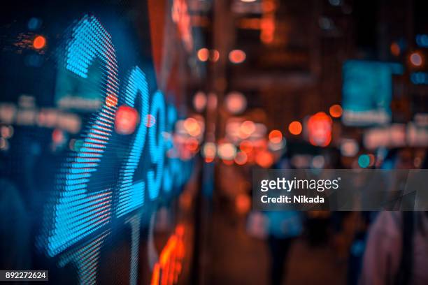 financial stock market numbers and city lights - finance and economy stock pictures, royalty-free photos & images