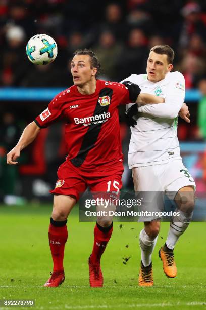 Julian Baumgartlinger of Bayer 04 Leverkusen battles for the ball with Maximilian Eggestein of Werder Bremen during the Bundesliga match between...