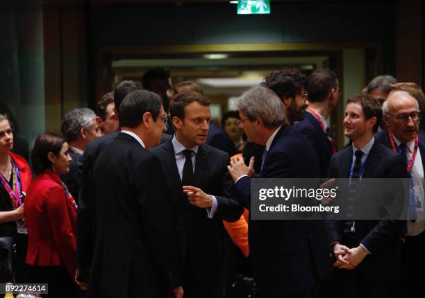 Emmanuel Macron, France's president, center, speaks to Paolo Gentiloni, Italy's prime minister, center right, ahead of a roundtable meeting at a...