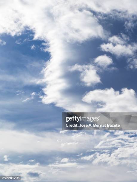 full frame of the low angle view of white color clouds  with a blue sky. valencian community, spain - powder blue foto e immagini stock