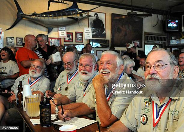 Past winners of the "Papa" Ernest Hemingway Look-Alike contest judge this year's contestants July 23 at Sloppy Joe's Bar in Key West, Florida. Around...